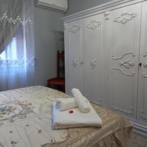 a bedroom with a bed with towels on it at HOME Lagana' in Messina