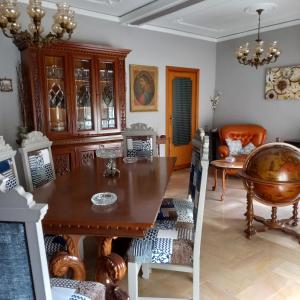 a dining room with a wooden table and chairs at HOME Lagana' in Messina