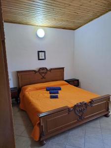 a bedroom with a bed with two blue pillows on it at Casa Solanas N. 2 in Solanas