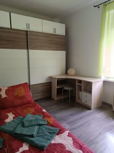 a bedroom with a bed with a desk and a table at Szava Angel in Budapest