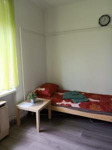 a small bedroom with a bed and a table at Szava Angel in Budapest