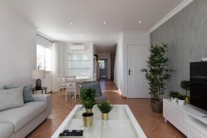 a living room with a couch and a table at NEW LISTING - Eden Villas in Vilamoura