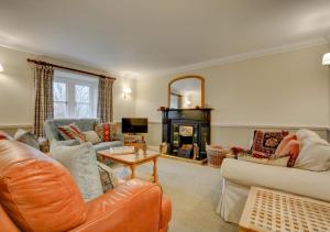 a living room with two couches and a fireplace at South View Cottage in Horton in Ribblesdale