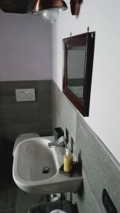 y baño con lavabo y espejo. en La Cà Rustica - casa vacanze, en Bognanco