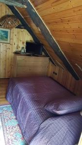 1 dormitorio con 1 cama en una cabaña de madera en La Cà Rustica - casa vacanze, en Bognanco