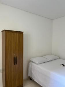 Ένα ή περισσότερα κρεβάτια σε δωμάτιο στο Suítes Paju