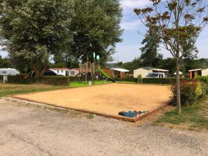 a basketball court with a bunch of balls on it at Camping Les Nysades in Mirepoix