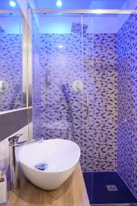 a bathroom with a sink and a glass shower at Hotel Terrazza Magenta in Rome