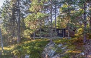 a log cabin in the woods with trees at Amazing Home In Stranda With 3 Bedrooms in Stranda
