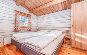 a bedroom with a bed in a room with wooden floors at Awesome Home In Stranda With House A Mountain View in Stranda