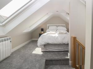 a bedroom with a bed in a attic at Bwthyn Cae'r Efail in Bodewryd