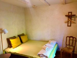 a small room with a bed and a cross on the wall at Kohtu Apartment Cozy in Kuressaare