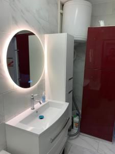 a bathroom with a white sink and a mirror at chez françois in Boulogne-sur-Mer