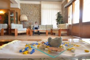 a room with a table with a plate of food on it at Hotel Stella Maris in Capoliveri