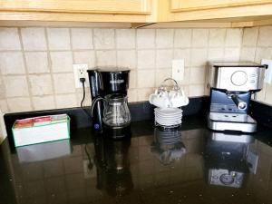 a counter top with a coffee maker and a blender at The Perfect Getaway (5 mins from Eugene Airport) in Eugene
