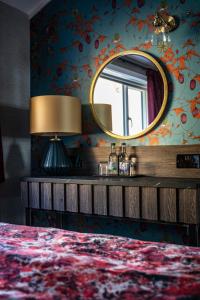 a bedroom with a large mirror and a bed at Duisdale House Hotel in Isleornsay