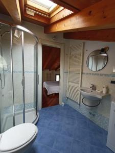 a bathroom with a shower toilet and a sink at Casa Marina in Lovere