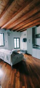 a bedroom with a bed and a wooden floor at Casa Marina in Lovere