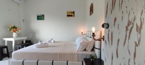 a bedroom with a bed with two candles on it at Wave Sound Apartments - Beach View in Skala Marion