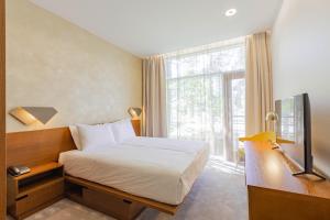 a hotel room with a bed and a window at NEW Rixwell Collection Seaside Hotel Jurmala in Jūrmala