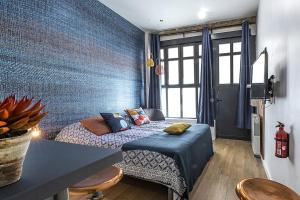 a small bedroom with a bed and a table and chairs at Le petit Claude Bernard - studio cosy Bellecour in Lyon