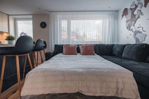 a living room with a large bed and a couch at NEW Luxury 3BR Apartment in Old Town, Free Parking in Haapsalu