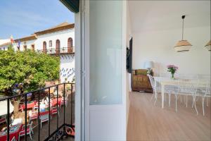 a room with a balcony with a table and chairs at Orange Square Rooftop Apartment 250 m2 in Marbella