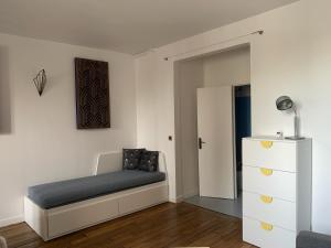 a small bedroom with a bed and a dresser at Studio perfect for 2 adults and 1 kid, and up to 2 kids - Jourdain 20e, 25mn to Louvre via line M11 in Paris