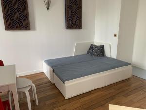 a bedroom with a bed and a table and chairs at Studio perfect for 2 adults and 1 kid, and up to 2 kids - Jourdain 20e, 25mn to Louvre via line M11 in Paris