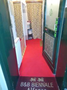 a hallway with a red carpet and a red floor at Biennale in Venice