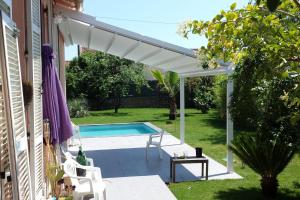 a white pergola over a swimming pool at Holiday house in the city-center of Antibes with a private pool in Antibes