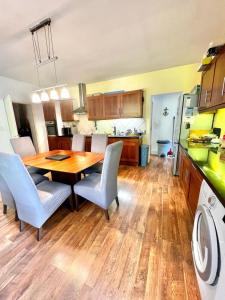 a kitchen and dining room with a wooden table and chairs at Holiday house in the city-center of Antibes with a private pool in Antibes