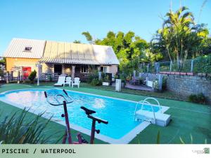 a swimming pool in front of a house at TI ZAZAKEL in Saint-Denis