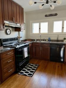 a kitchen with black appliances and wooden cabinets at Historic Oak Park Residence in Oak Park