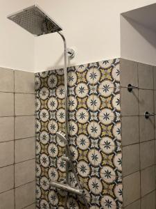 a shower with a shower curtain in a bathroom at CASA n 61 in Dervio +25 photos