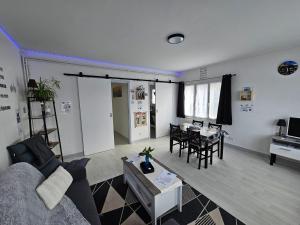 a living room with a couch and a table at Le Bellevue in Givet