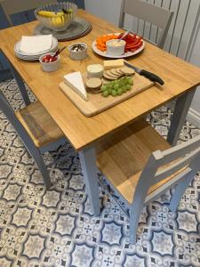 a wooden table with a plate of food on it at Tower Street Cottage in Richmond