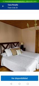a picture of a bedroom with a white bed at Casa Rosalia in Lobios