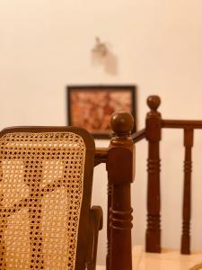 a chair sitting next to a table with a picture at The Tourist Balcony in Negombo