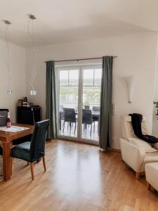 a living room with a table and a couch at Lake View Apartment Seecorso in Velden am Wörthersee