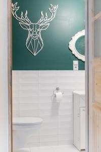 a bathroom with a reindeer decal on the wall at Apartamenty Przylesie in Polanica-Zdrój