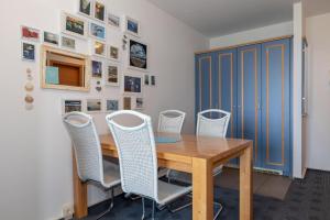 a dining room with a wooden table and chairs at Yachthafenresidenz-Wohnung-5203-812 in Kühlungsborn