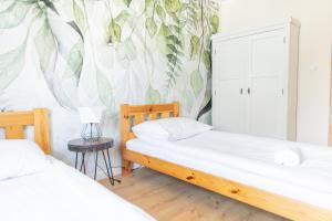 Posteľ alebo postele v izbe v ubytovaní Apartamenty Przylesie
