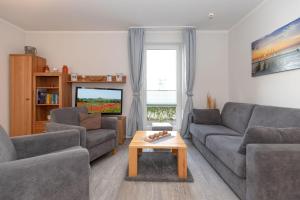 a living room with two couches and a coffee table at Yachthafenresidenz-Wohnung-6101-818 in Kühlungsborn