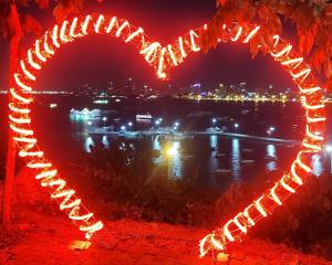 a heart shaped light display at night with a city at Laguna Beach Resort3 in Jomtien Beach