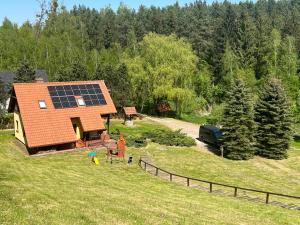 an aerial view of a house with a solar roof at Domek w Gaju in Gaj Grzmięca