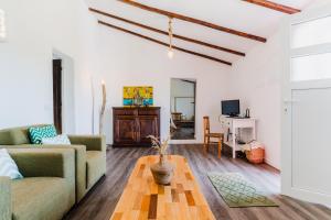 a living room with a couch and a table at Casa Alfambras - Holiday Cottage in Aljezur in Aljezur