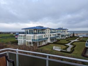 a large apartment building with a view of the ocean at Yachthafenresidenz-Wohnung-5303-815 in Kühlungsborn