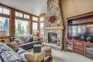 a living room with a fireplace and a tv at East Keystone by Keystone Resort in Keystone