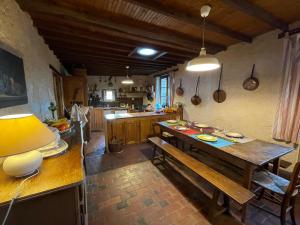 a kitchen with a wooden table and a dining room at Gite Ligerie in Saint-Martin-des-Pézérits